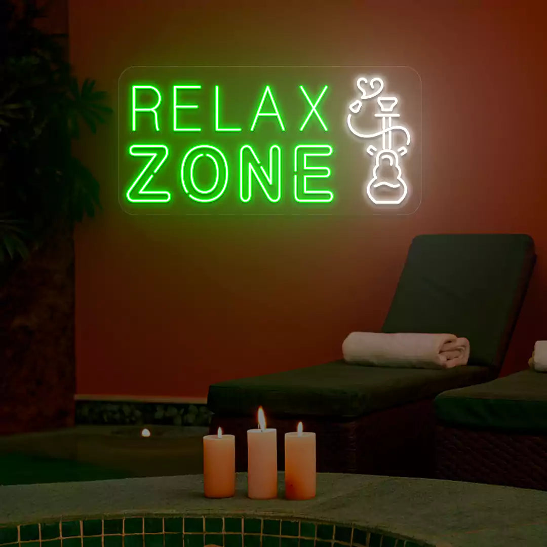 Green and white Relax Zone neon sign glowing on a wall