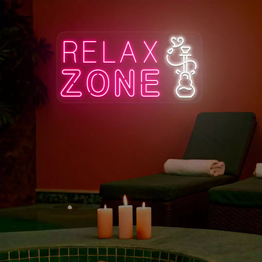 Pink and white Relax Zone neon sign glowing on a wall