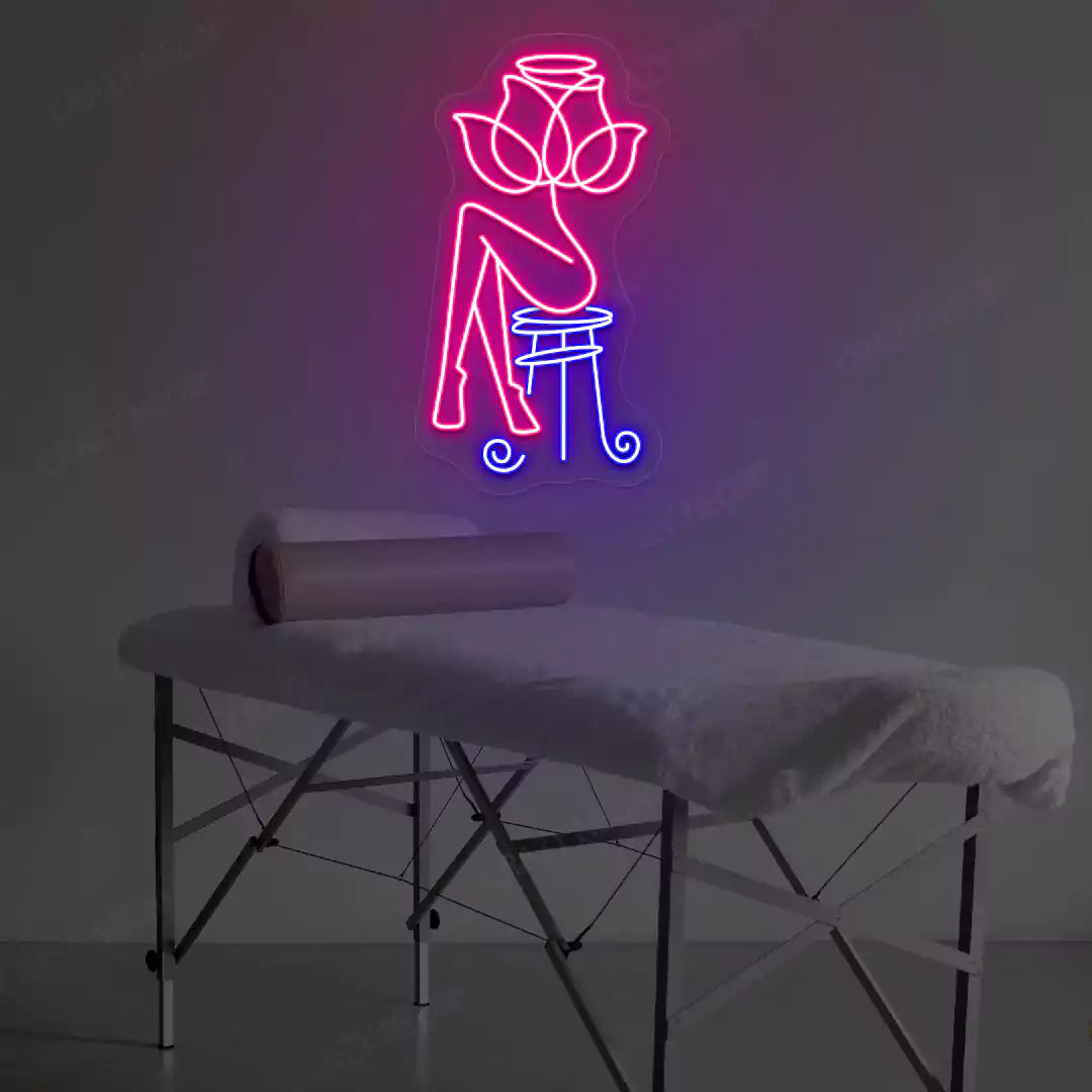 Rose Bliss Spa neon sign in pink and blue colors glowing in a spa room