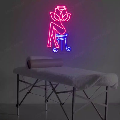 Rose Bliss Spa neon sign in pink and blue colors glowing in a spa room