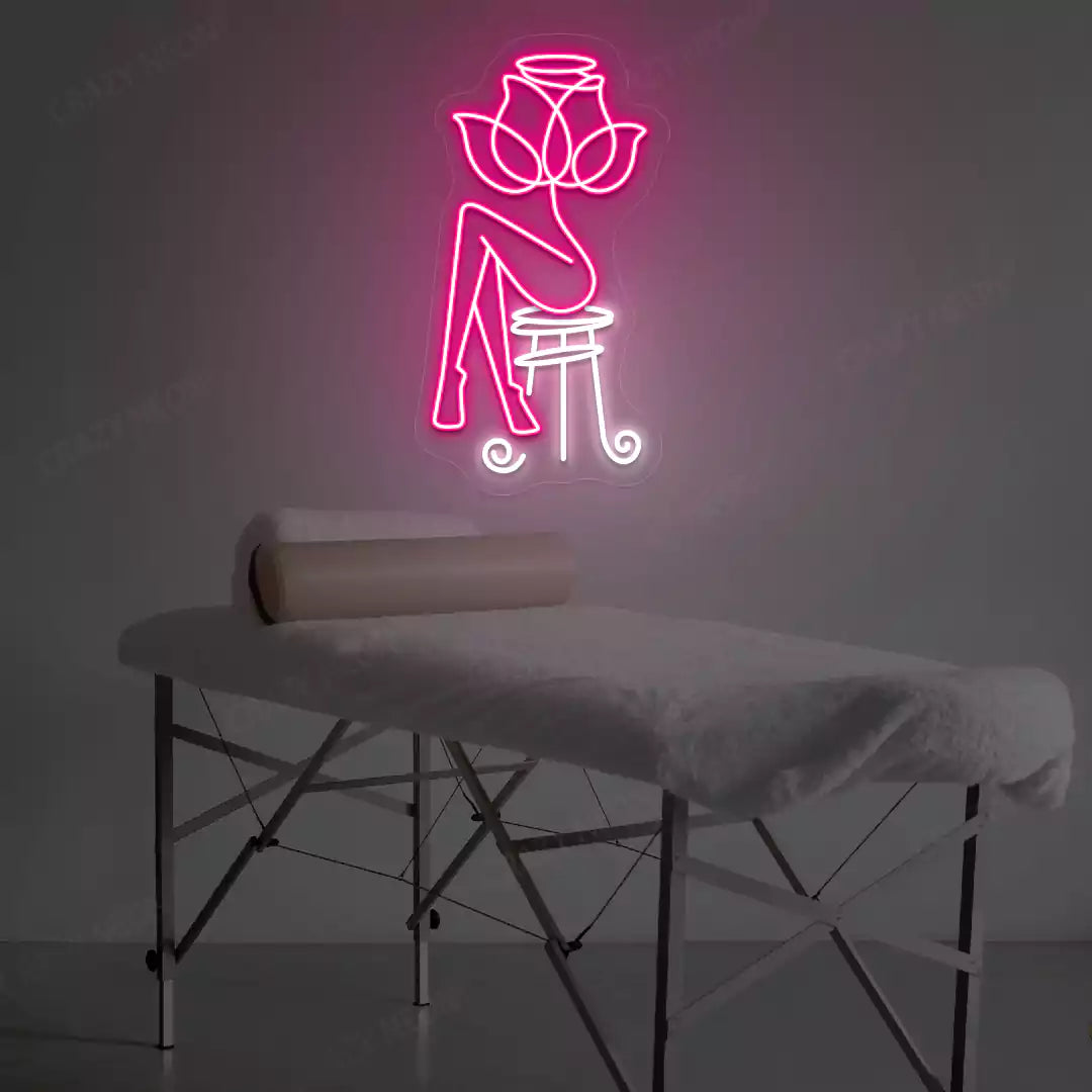 Rose Bliss Spa neon sign in pink and white colors glowing in a spa room
