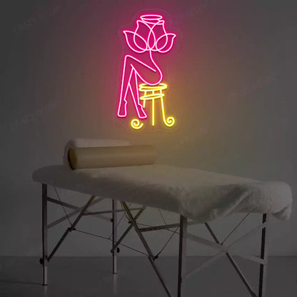 Rose Bliss Spa neon sign in pink and yellow colors glowing in a spa room