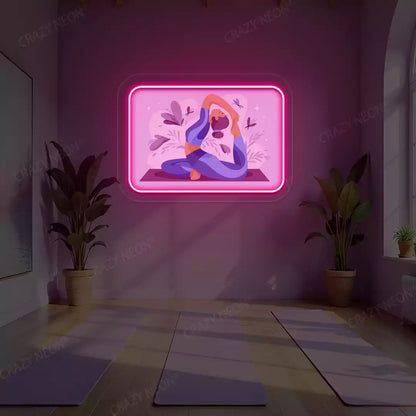 Rajakapotasana Yoga Neon Artwork lighting up in pink color in a yoga room
