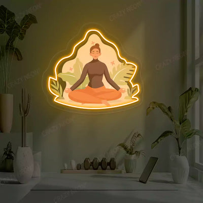 Sukhasana Leaf Yoga Neon Artwork lighting up in orange color in a yoga room