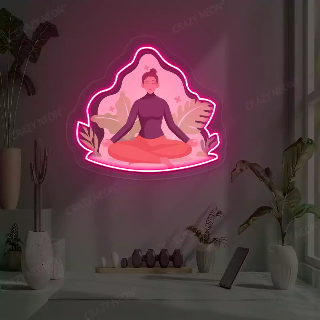 Sukhasana Leaf Yoga Neon Artwork lighting up in pink color in a yoga room