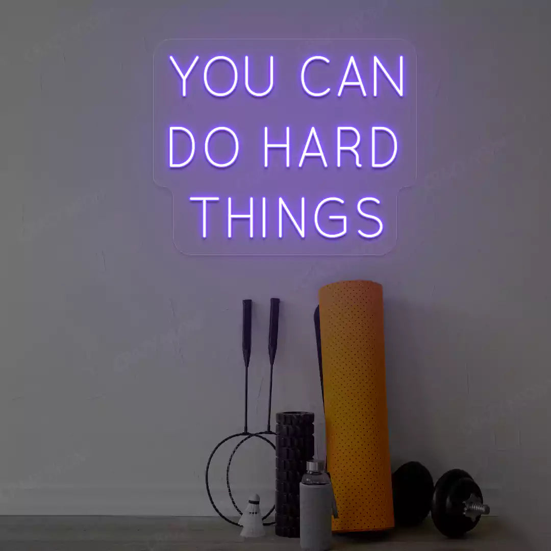 purple you can do hard things neon sign mounted on a wall