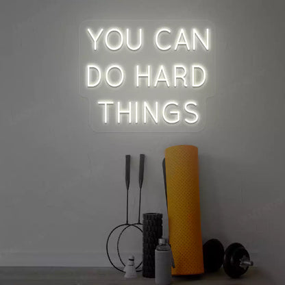 warm white you can do hard things neon sign mounted on a wall