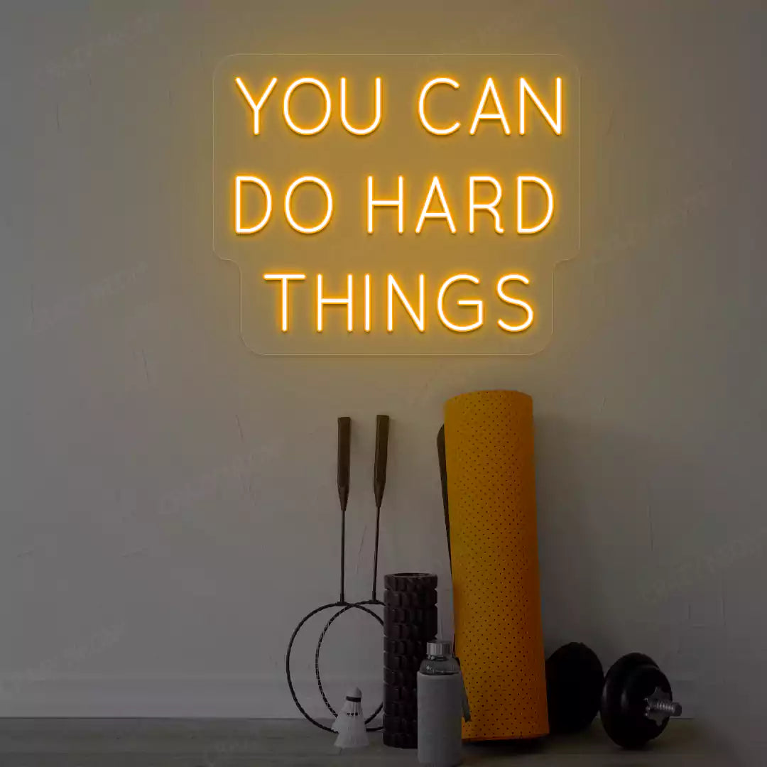 orange you can do hard things neon sign mounted on a wall
