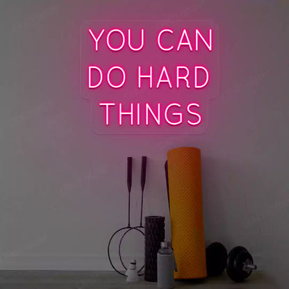 pink you can do hard things neon sign mounted on a wall