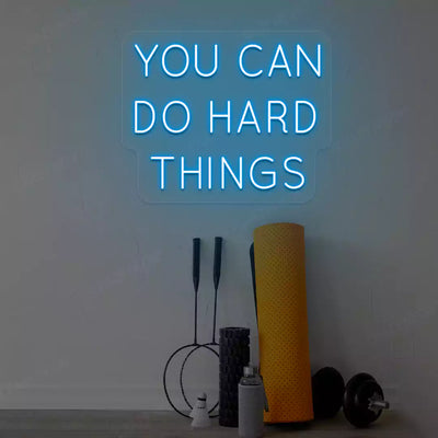 ice blue you can do hard things neon sign mounted on a wall