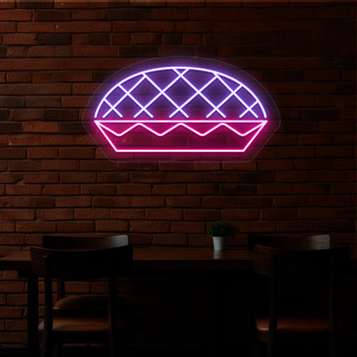 Harvest pie neon sign in purple and pink.