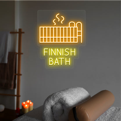 Finnish Bath neon sign in orange and yellow colors glowing in a spa room
