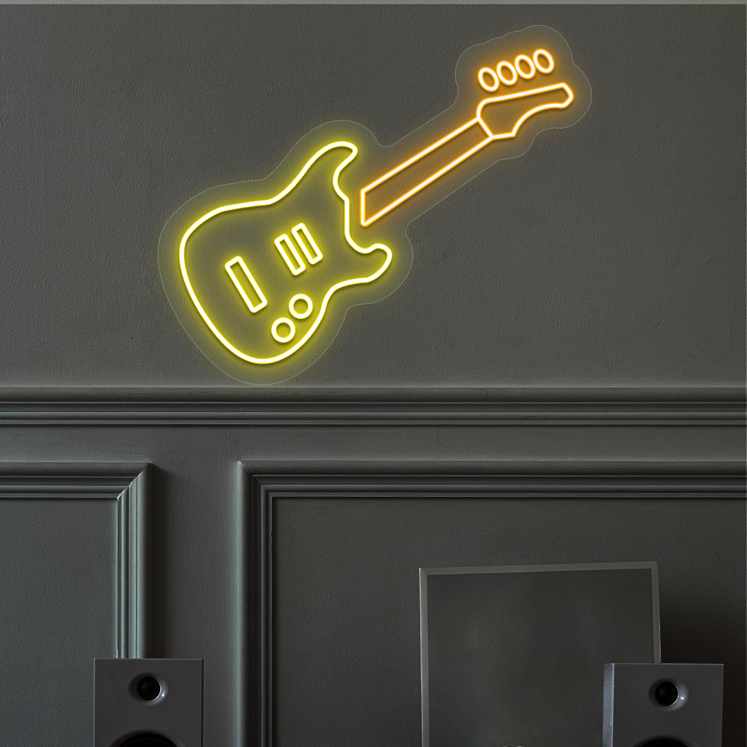 yellow and orange electric guitar neon sign mounted on a wall