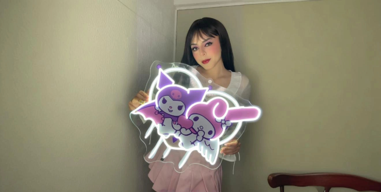 Woman holding Kuromi and My Melody pastel neon sign for kawaii room decor