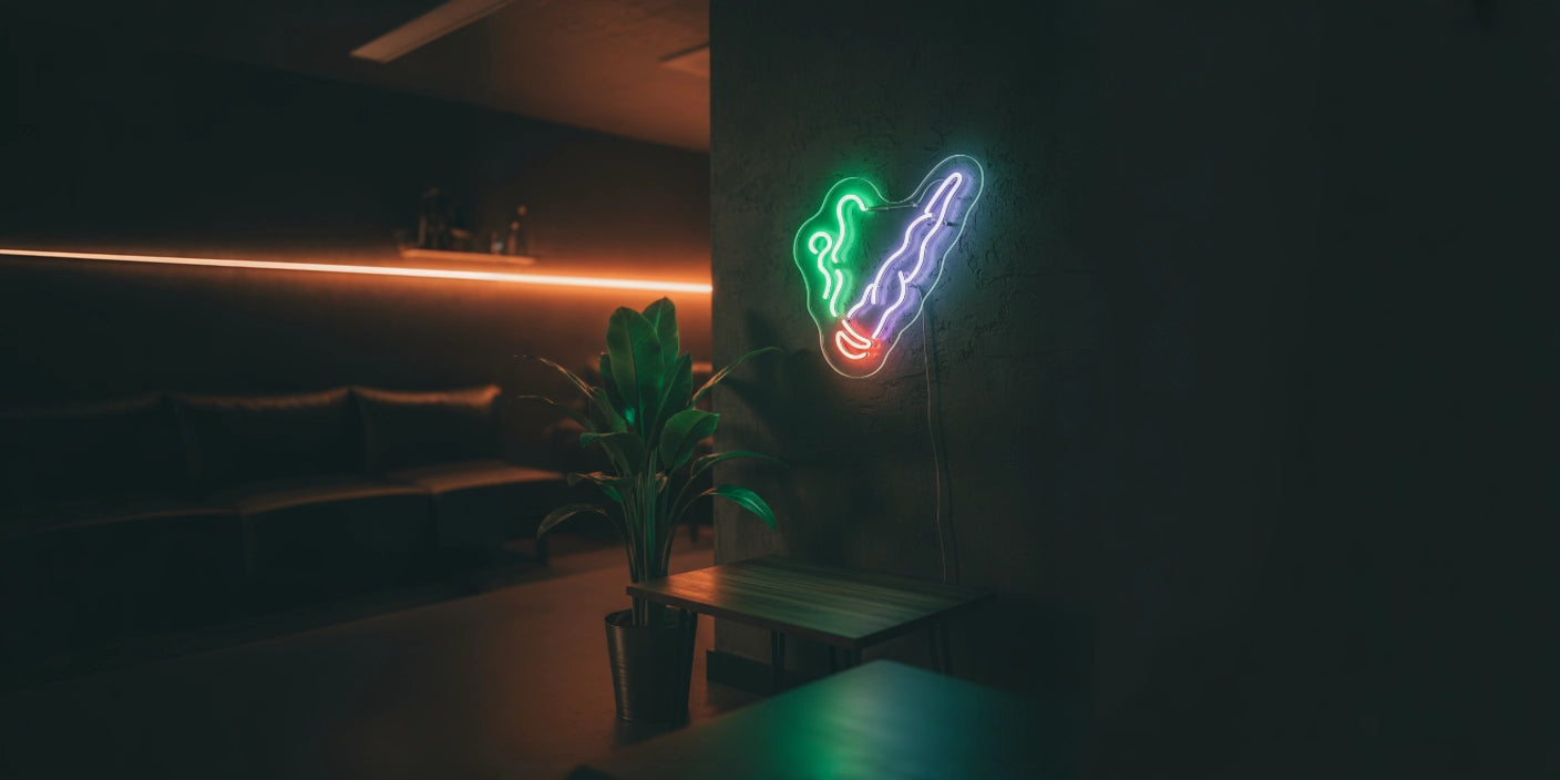 Colorful weed leaf neon sign glowing on dark wall in modern lounge setting
