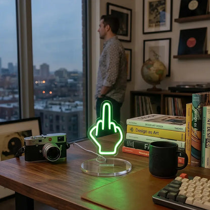 Green neon hand gesture desk lamp with a bold outline design glowing on a modern workspace desk
